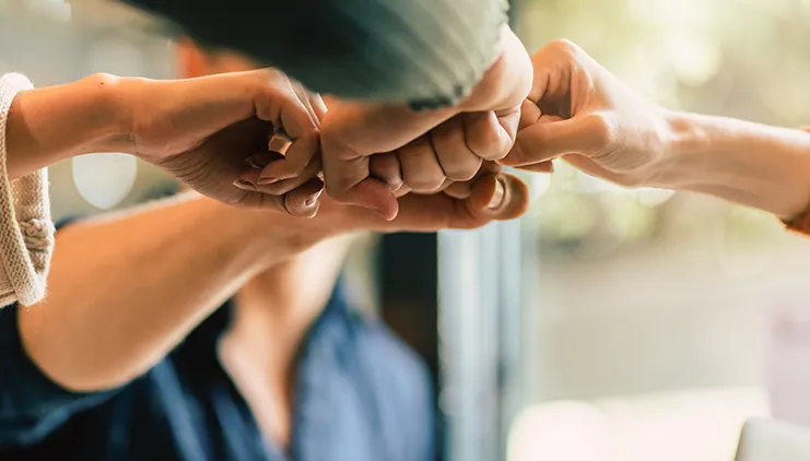 Team fist bumping for leadership and management