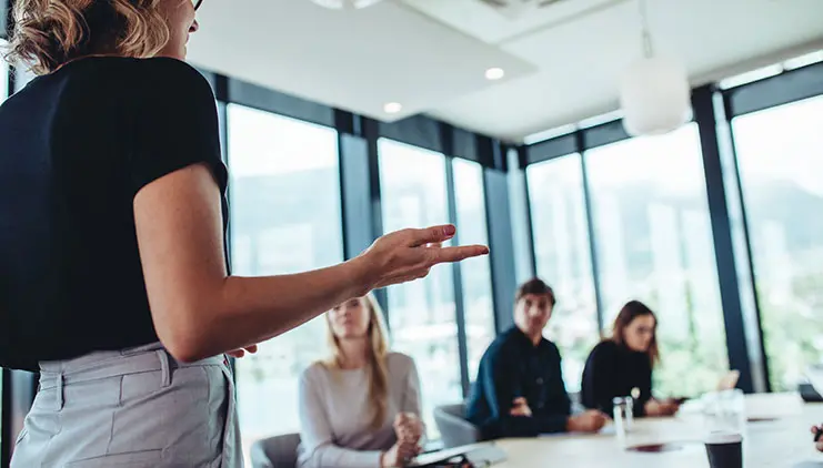 Woman presenting to colleagues