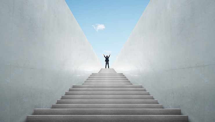 Long staircase with a person celebrating at the top