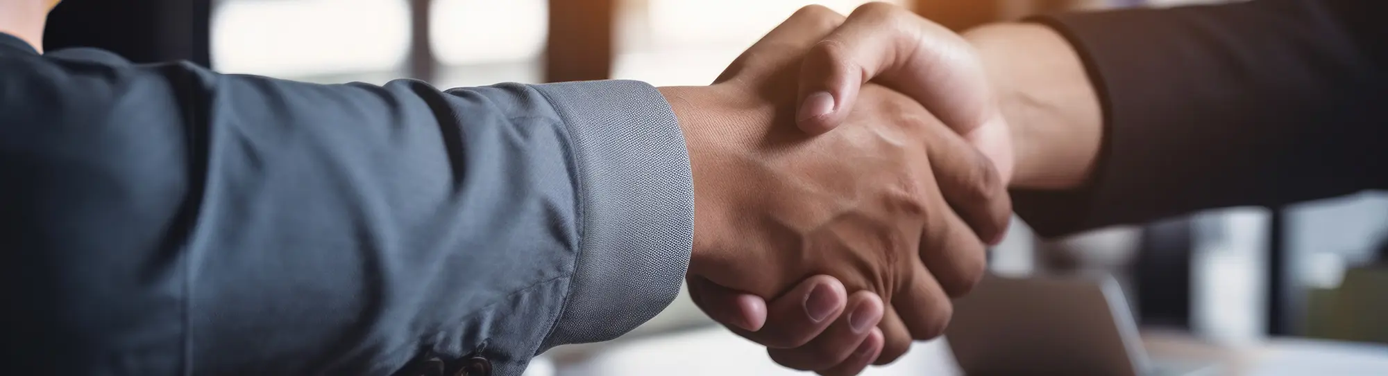 close up of 2 people doing a business handshake