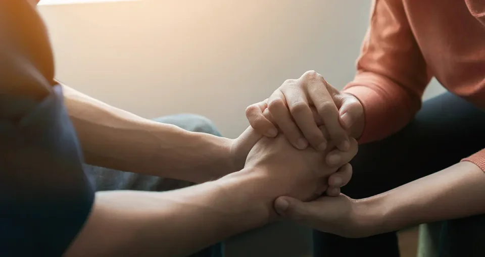 Hands holding for comfort.